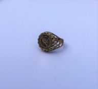 A 9 carat ring mounted with a gold coin. Approx. 4