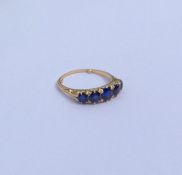 A sapphire and diamond half hoop ring in 18 carat