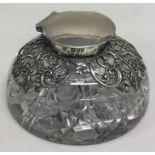 A heavy circular silver mounted inkwell with hinge