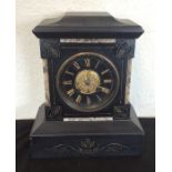 An Edwardian slate mantle clock with silver dial.
