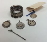 A small silver watch medallion, napkin ring etc. A