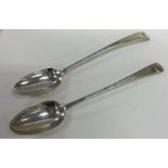 A pair of heavy Irish silver basting spoons with b