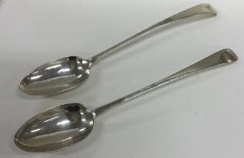 A pair of heavy Irish silver basting spoons with b