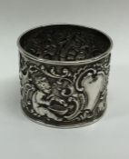 A heavy silver embossed napkin ring decorated with