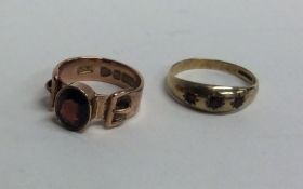Two garnet buckle rings in 9 carat mount. Approx.