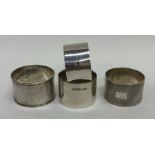 A group of four silver napkin rings. Various dates