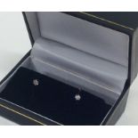 A pair of small diamond single stone ear studs in