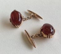 A pair of gold and cornelian cufflinks contained w