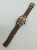 A 9 carat lady's wristwatch on mesh strap. Approx.