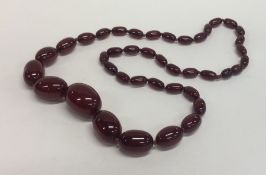 A graduated string of red amber beads with conceal