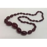 A graduated string of red amber beads with conceal