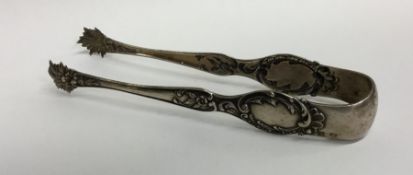 A pair of Continental silver sugar tongs decorated