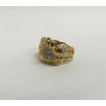 A large heavy gent's 18 carat ring with textured d