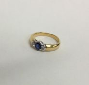 A heavy sapphire and diamond three stone gypsy set