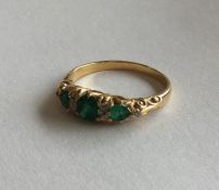 An emerald and diamond eight stone ring in 18 cara