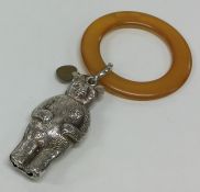 An Edwardian silver rattle in the form of a bear.