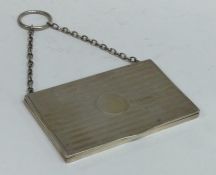 An engine turned silver card case on suspension ch