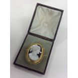 A cased hard stone cameo of a lady in gold frame w