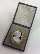 A cased hard stone cameo of a lady in gold frame w