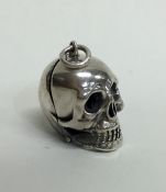 An Antique silver pill box in the form of a skull