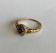 An attractive ruby and diamond cluster ring in 18