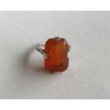 A large rectangular fire opal mounted as a ring in