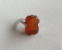 A large rectangular fire opal mounted as a ring in