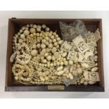 A box containing carved and other ivory bead neckl