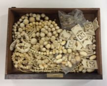 A box containing carved and other ivory bead neckl