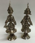 A pair of large Continental silver figures decorat