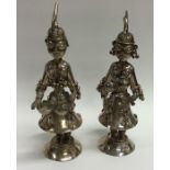A pair of large Continental silver figures decorat