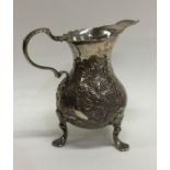 A Georgian embossed helmet shaped cream jug. Londo