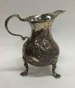 A Georgian embossed helmet shaped cream jug. Londo