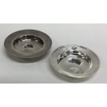 Two circular modern silver armada dishes with reed