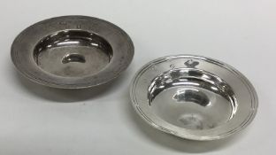 Two circular modern silver armada dishes with reed