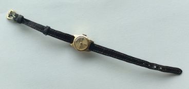 A lady's 18 carat wristwatch on leather strap. App