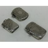A group of three silver engraved vesta cases. Appr