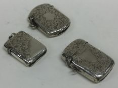 A group of three silver engraved vesta cases. Appr