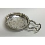 An early Scottish silver lemon strainer with scrol