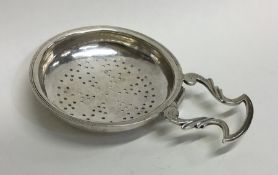 An early Scottish silver lemon strainer with scrol