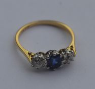 An 18 carat gold sapphire and diamond three stone