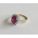 A ruby and diamond cluster ring in 18 carat claw m