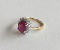 A ruby and diamond cluster ring in 18 carat claw m