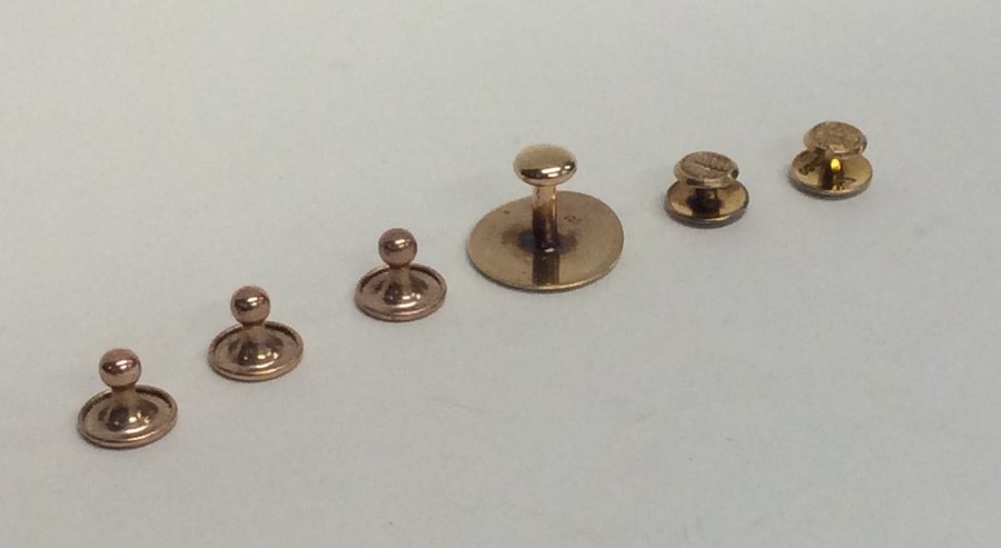 A group of 9 carat buttons. Approx. 5.6 grams. Est