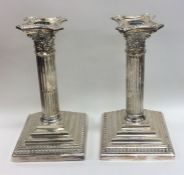 A good pair of Corinthian column candlesticks with