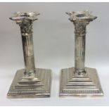 A good pair of Corinthian column candlesticks with