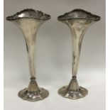 A pair of Edwardian silver tapering spill vases on