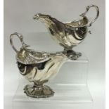 A pair of good early Georgian silver sauce boats w
