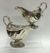 A pair of good early Georgian silver sauce boats w