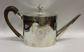 A good Georgian bright cut silver teapot decorated